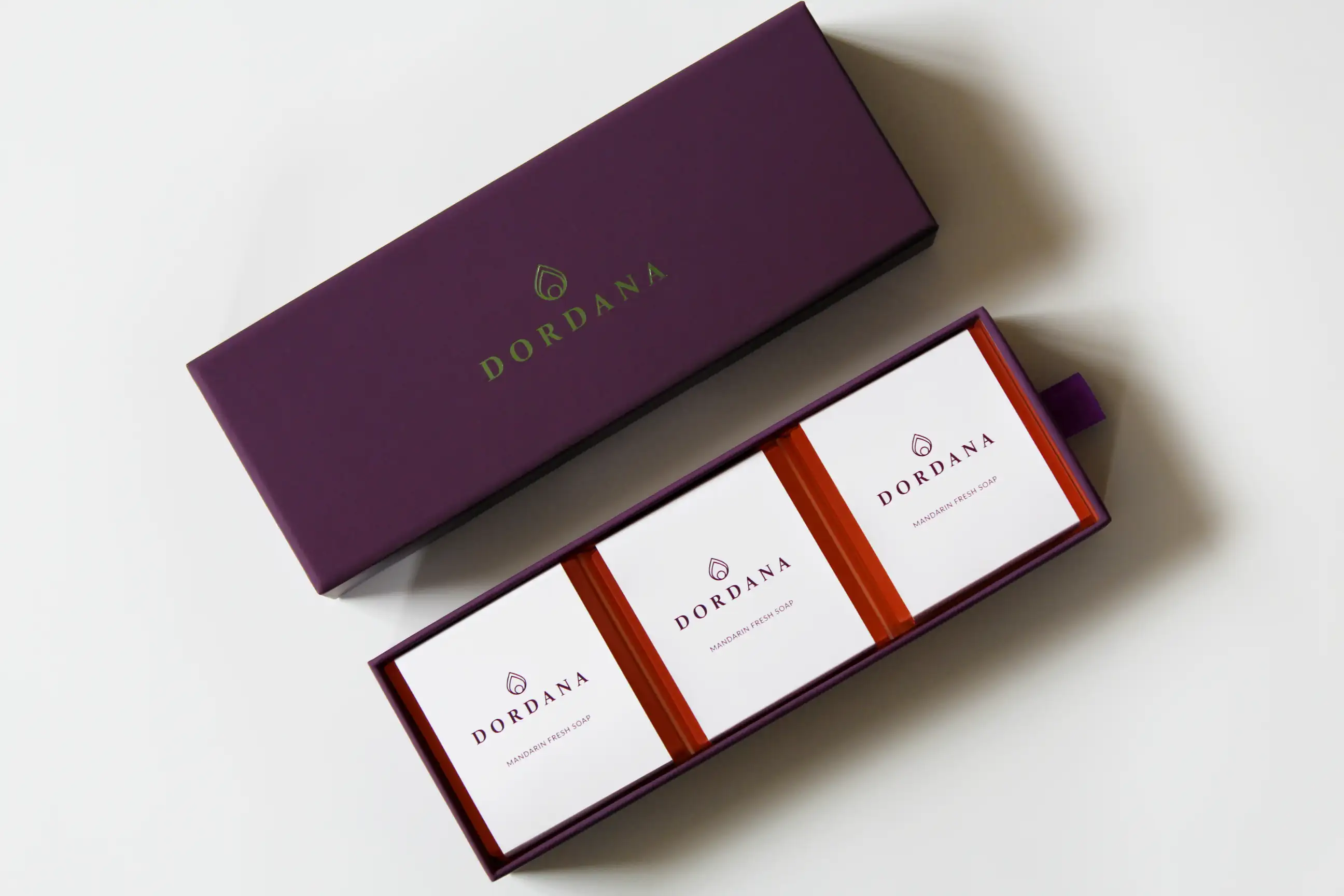 The three Dordana soap bars of the Mandarin Fresh Trio comfortably housed in their purple presentation box.